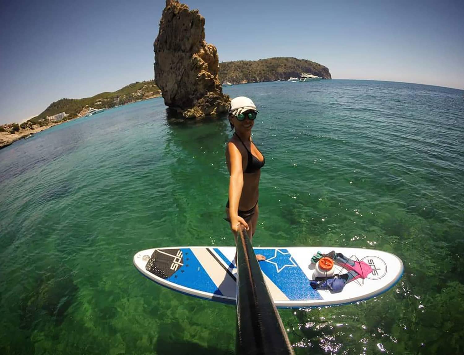 Girl standing in a Blue Evo Sup making a selfie in front of a rock