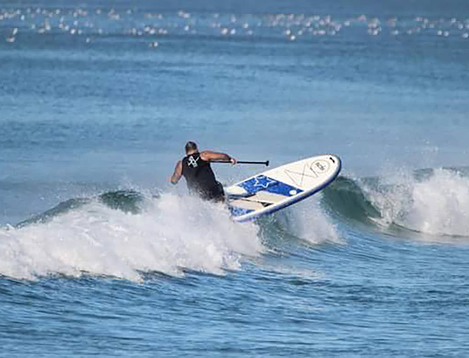 Man surfing a wave with a Blue Evo Sup